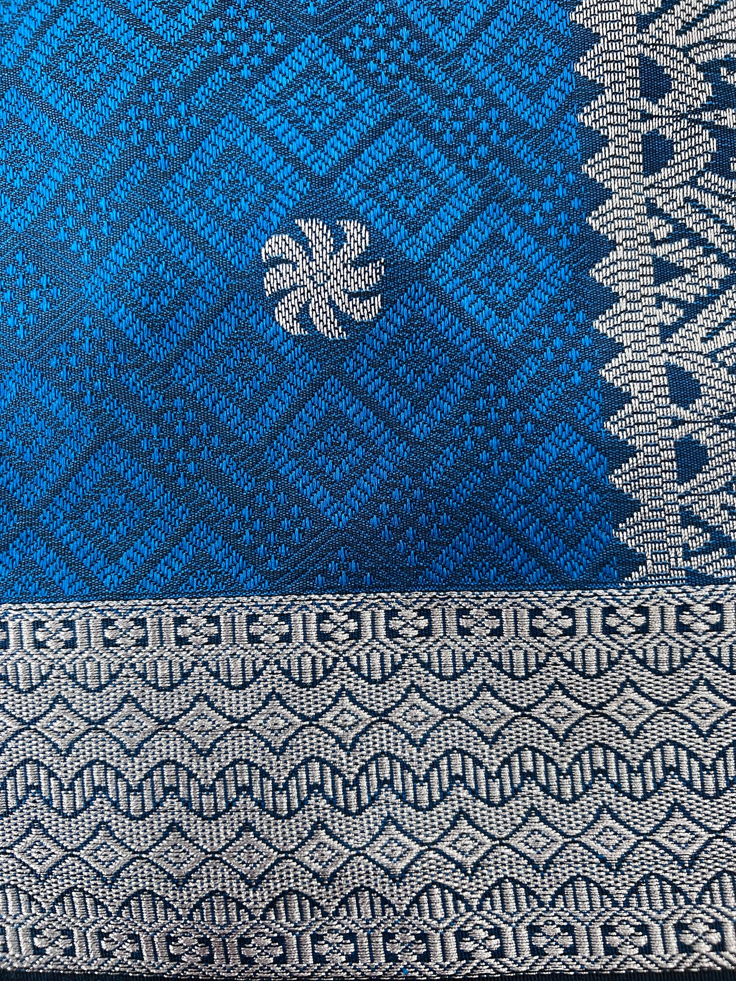 Close-up of a blue and gray woven fabric with geometric patterns