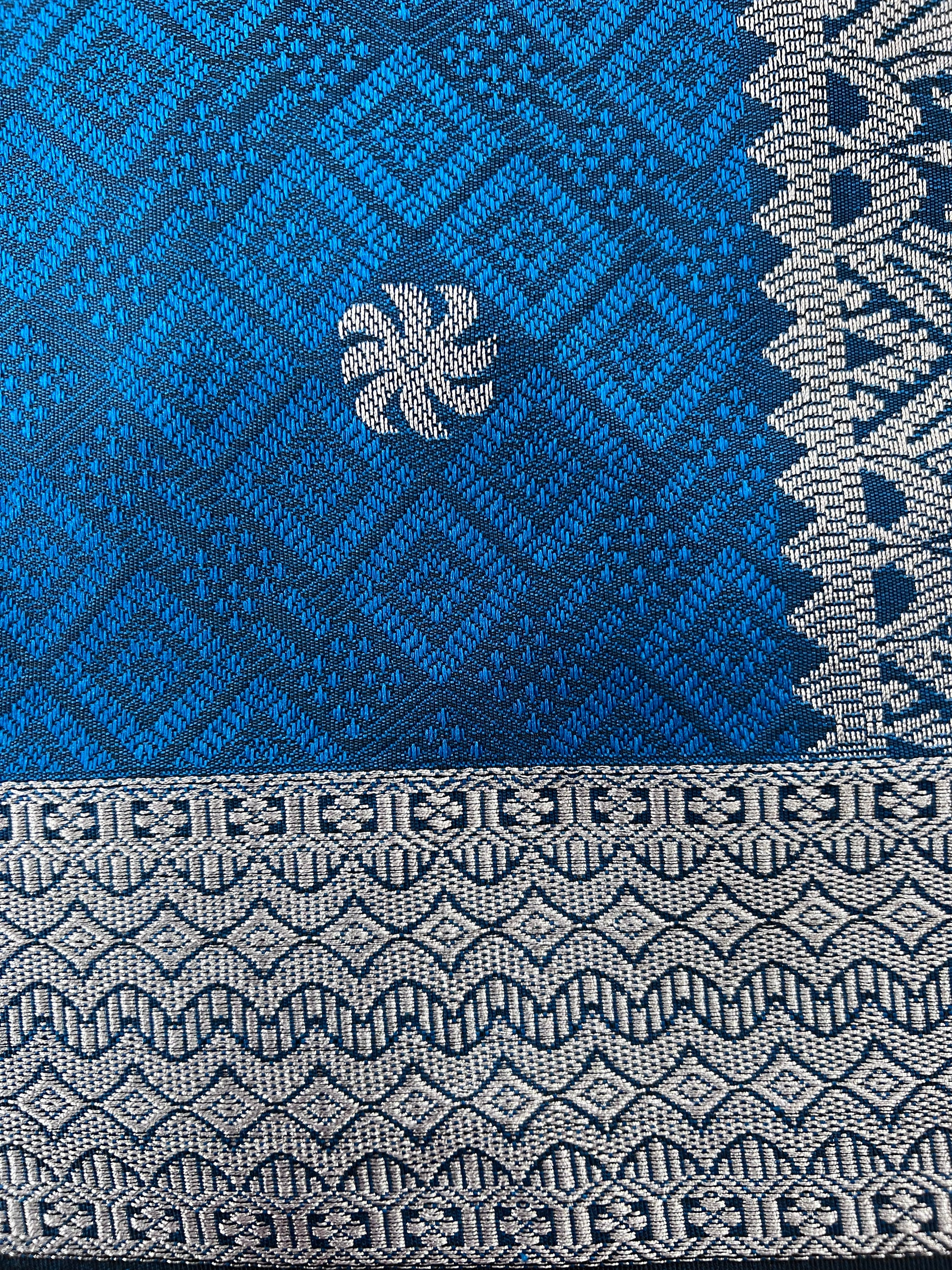 Close-up of a blue and gray woven fabric with geometric patterns