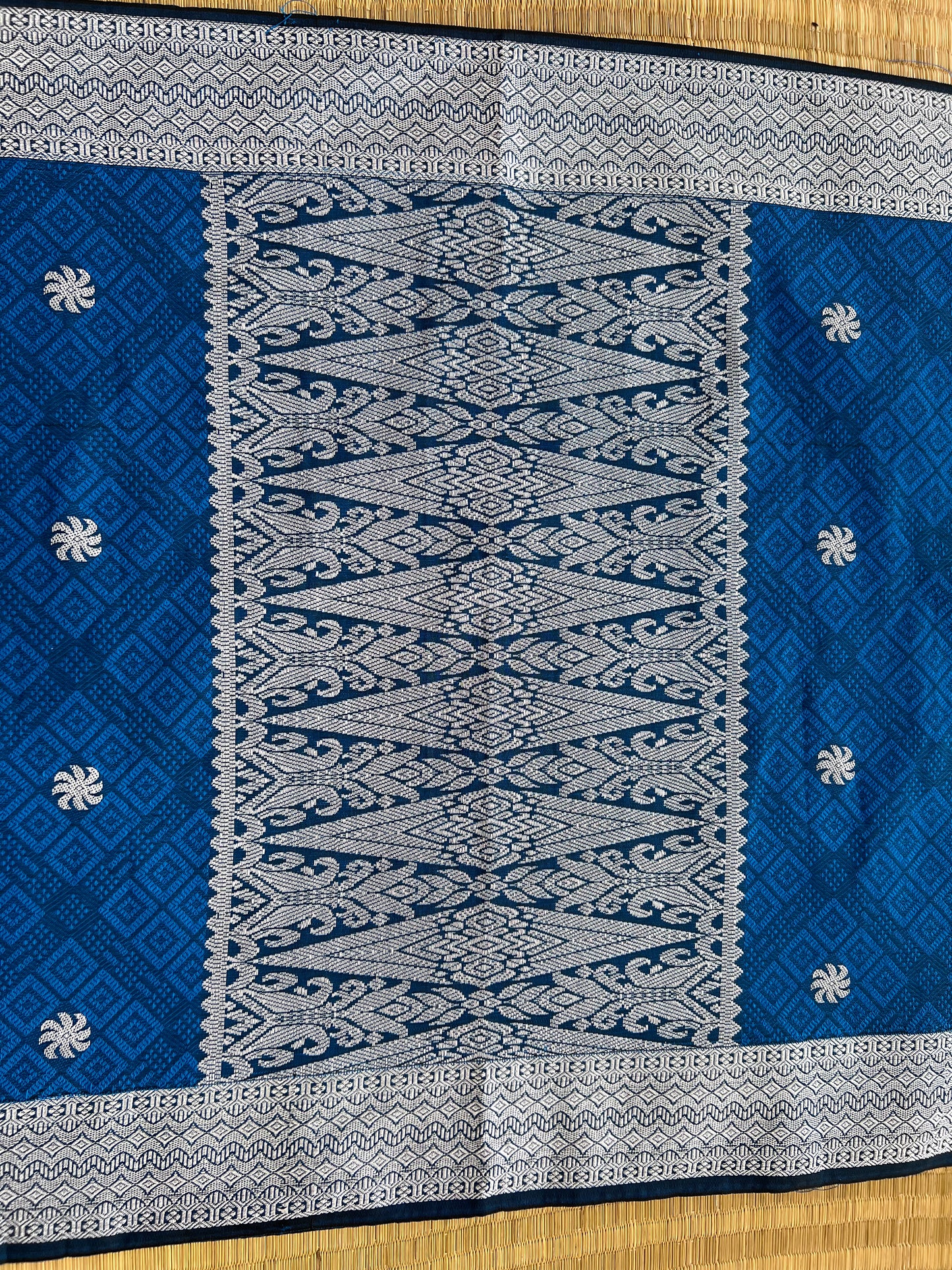 Blue and white patterned fabric on a wooden surface